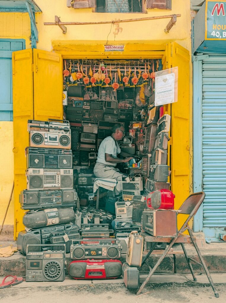 A vibrant street scene of a vintage electronics shop in Kolkata, India.